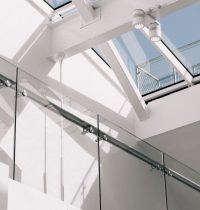 low-angle-shot-modern-building-interior-with-white-walls-touching-sky-min